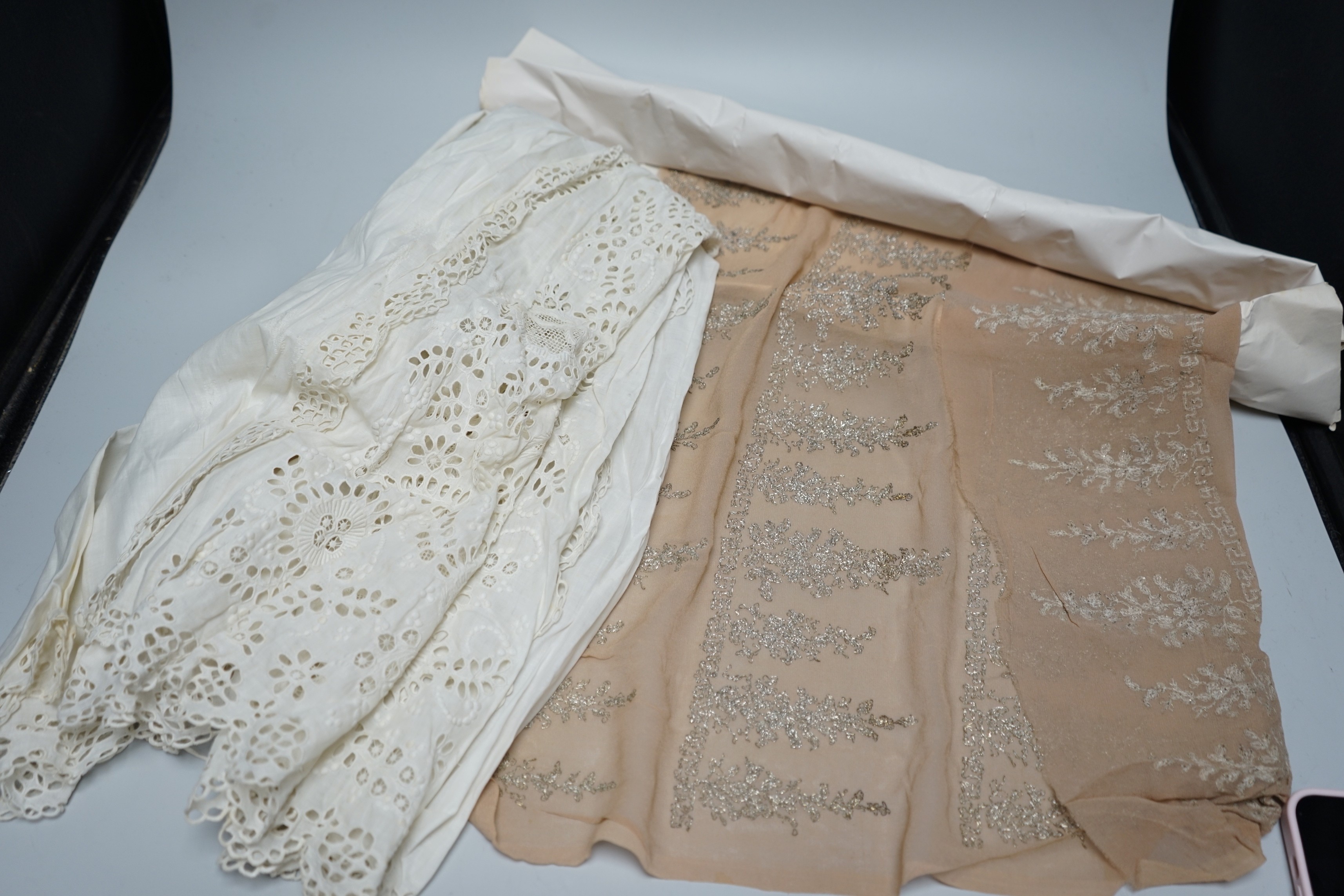 A long length of 1930’s silver lace trimming a similar panel, chiffon and silver embroidered fabric, an ornate 19th century cut worked christening gown etc